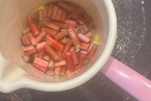 Chopped forced rhubarb simmering with orange for rhubarb polenta cake