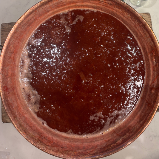 Jam reaching setting point in copper jam pan